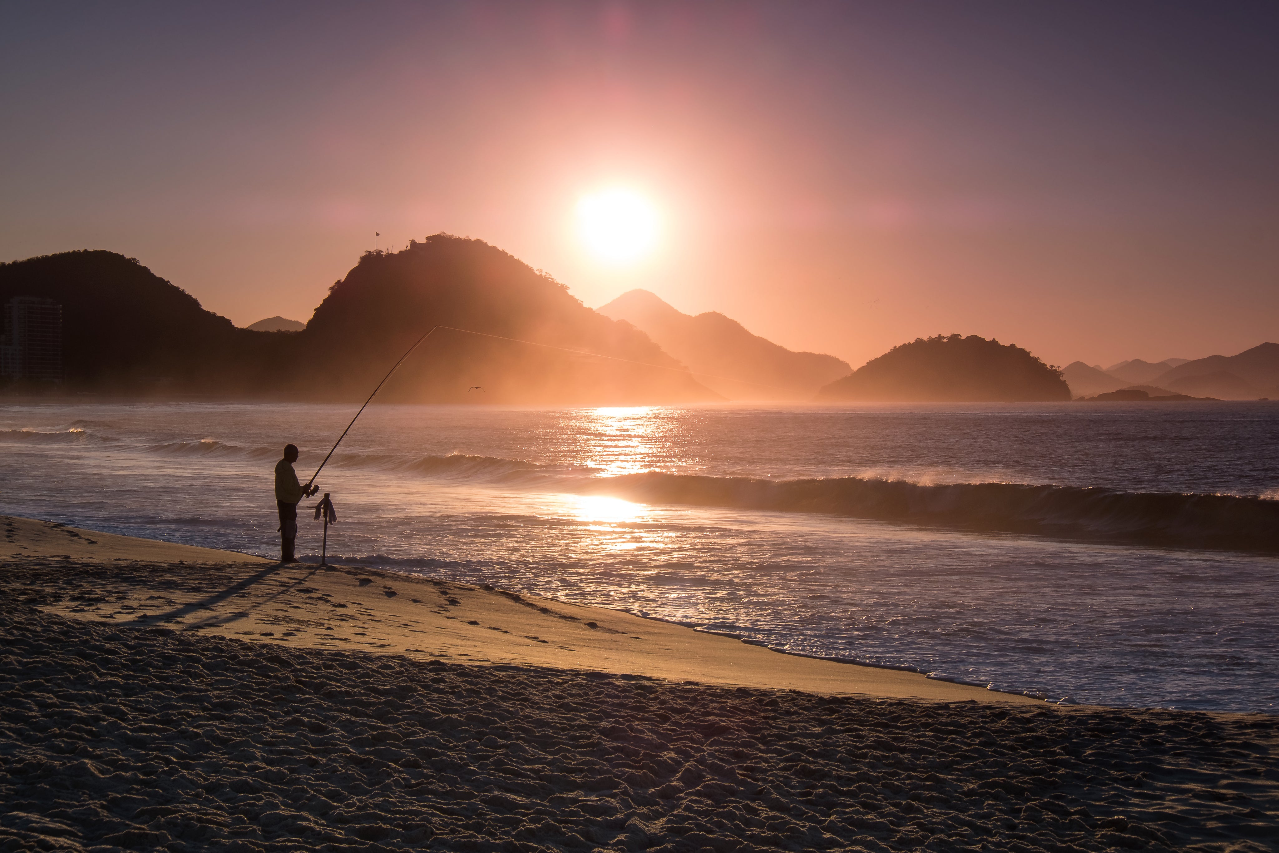 files/person-fishing-on-the-beach-is-silhouetted-at-sunset.jpg